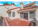 Tiled back patio with stucco walls and sliding glass doors at 6914 Emerald Springs Ln, Las Vegas, NV 89113