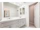 Bathroom features double sinks, white cabinets, a large mirror, and a walk-in closet at 6914 Emerald Springs Ln, Las Vegas, NV 89113