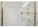 A white tiled bath and shower combo feature gold trim and a glass door at 6914 Emerald Springs Ln, Las Vegas, NV 89113