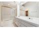 Bathroom featuring double sinks, tile floors, and glass-enclosed shower at 6914 Emerald Springs Ln, Las Vegas, NV 89113