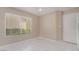 Cozy bedroom with white tiled floors, a window with blinds, and a white door at 6914 Emerald Springs Ln, Las Vegas, NV 89113