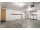 Spacious garage with laundry area, refrigerator, and extra storage at 6914 Emerald Springs Ln, Las Vegas, NV 89113