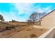 An arid landscape with sparse trees overlooking a distant golf course at 6914 Emerald Springs Ln, Las Vegas, NV 89113