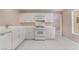 Well-lit kitchen with modern appliances, white cabinetry, and functional layout for cooking at 6914 Emerald Springs Ln, Las Vegas, NV 89113