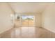 Bright living room with hardwood floors, a sliding glass door, and a window with blinds at 6914 Emerald Springs Ln, Las Vegas, NV 89113