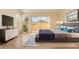 Staged main bedroom featuring a view, sliding glass door, modern decor and hardwood floors at 6914 Emerald Springs Ln, Las Vegas, NV 89113