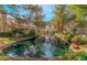 A serene pond surrounded by trees and lush greenery near residences at 6914 Emerald Springs Ln, Las Vegas, NV 89113