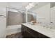 Bathroom with double vanity, large mirror, and bathtub at 7646 Sandhaven St, Las Vegas, NV 89139