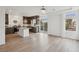 Modern kitchen features island, dark cabinetry, and hardwood floors at 7646 Sandhaven St, Las Vegas, NV 89139