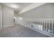 Bright loft area features neutral carpeting, fresh paint, and white railing overlooking the floor below at 7877 Running Doe Ct, Las Vegas, NV 89149