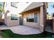 An exterior shot of a charming back patio area with paver stones and artificial turf at 8063 Sundance Valley Dr, Las Vegas, NV 89178