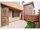 View of the backyard, with an attractive paver patio, artificial turf, and a security gate at 8063 Sundance Valley Dr, Las Vegas, NV 89178