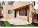 Back patio with a covered area, access door, decorative rocks, and artificial turf at 8063 Sundance Valley Dr, Las Vegas, NV 89178