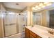 Bathroom with dual sinks, vanity, shower and tub with glass door at 8063 Sundance Valley Dr, Las Vegas, NV 89178