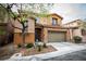 Charming two-story home featuring stone accents, a two-car garage, and landscaped front yard at 8063 Sundance Valley Dr, Las Vegas, NV 89178