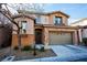 Two-story house with stone accents and a two-car garage at 8063 Sundance Valley Dr, Las Vegas, NV 89178