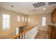 Upstairs hallway with wood railing, and a cabinet for storage in the home's design at 8063 Sundance Valley Dr, Las Vegas, NV 89178