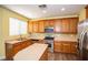 Well-equipped kitchen with stainless steel appliances, wooden cabinets, and natural lighting at 8063 Sundance Valley Dr, Las Vegas, NV 89178
