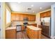Well-equipped kitchen with stainless steel appliances, wooden cabinets, and a functional island at 8063 Sundance Valley Dr, Las Vegas, NV 89178