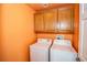 Laundry room with washer and dryer and cabinets above at 8063 Sundance Valley Dr, Las Vegas, NV 89178