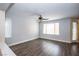 Bright living room featuring hardwood floors, neutral walls, and an elegant ceiling fan at 8063 Sundance Valley Dr, Las Vegas, NV 89178