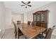 Formal dining room with a large table, hutch, and ceiling fan at 8220 Redbud Vine St, North Las Vegas, NV 89085