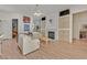 Living room with hardwood floors, fireplace, and a view of the kitchen at 8557 Summer Vista Ave, Las Vegas, NV 89145