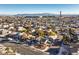 This aerial view shows the property and neighborhood with the airport in the background at 889 Monika Way, Las Vegas, NV 89119