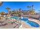 Backyard showcasing pool, spa, and a seating area surrounded by tall palm trees at 889 Monika Way, Las Vegas, NV 89119