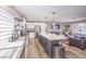 Bright kitchen featuring an island, stainless steel appliances, and an open layout connecting to the living room at 889 Monika Way, Las Vegas, NV 89119