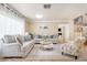 Spacious living room featuring light beige sofas and a stylish coffee table at 9377 Lotus Elan Dr, Las Vegas, NV 89117