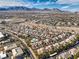 Aerial view of houses, pool, and mountain backdrop at 10205 Birch Bluff Ln, Las Vegas, NV 89145