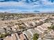 High-angle showcases a well-organized neighborhood layout surrounded by desert terrain with mountains in the distance at 10205 Birch Bluff Ln, Las Vegas, NV 89145