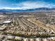 Impressive aerial view emphasizes the community's integration with its desert environment against the backdrop of distant mountains at 10205 Birch Bluff Ln, Las Vegas, NV 89145