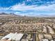 Picturesque aerial captures the city's residential area with mountain backdrop on a sunny day, showing scale and location at 10205 Birch Bluff Ln, Las Vegas, NV 89145