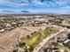 Stunning aerial shot featuring a meticulously maintained community amidst desert landscape and distant city buildings at 10205 Birch Bluff Ln, Las Vegas, NV 89145