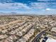 Vast aerial panorama shows the neighborhood blending into the natural desert landscape, offering serene living with city access at 10205 Birch Bluff Ln, Las Vegas, NV 89145