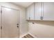 Bright laundry room with new cabinets and vinyl flooring at 10205 Birch Bluff Ln, Las Vegas, NV 89145