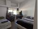 Bedroom with two beds and a window at 10524 Pine Gardens Ct # 203, Las Vegas, NV 89144