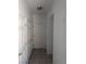 Hallway with tile flooring, multiple closets and neutral walls creating a clean and organized entrance at 10524 Pine Gardens Ct # 203, Las Vegas, NV 89144