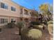 Exterior view of condo showing balconies and desert landscaping at 10524 Pine Gardens Ct # 203, Las Vegas, NV 89144