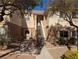 Inviting two-story condo featuring an open-air staircase entrance and desert landscaping at 10524 Pine Gardens Ct # 203, Las Vegas, NV 89144