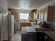 Charming kitchen with white appliances, light wood cabinets, and a breakfast bar at 10524 Pine Gardens Ct # 203, Las Vegas, NV 89144