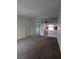 Open living room leading to a kitchen with white cabinets and a breakfast bar at 10524 Pine Gardens Ct # 203, Las Vegas, NV 89144