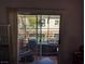An outdoor patio space seen through sliding glass doors that leads to the balcony at 10524 Pine Gardens Ct # 203, Las Vegas, NV 89144