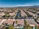 Aerial neighborhood view showcasing manicured streets and homes with private pools at 10649 Bella Ordaz Way, Las Vegas, NV 89141