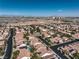 Aerial view of a neighborhood showcasing the city skyline in the distance at 10649 Bella Ordaz Way, Las Vegas, NV 89141