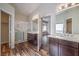 Bathroom with double sink vanity, glass shower, and a view to bedroom at 10649 Bella Ordaz Way, Las Vegas, NV 89141