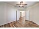 Spacious bedroom featuring wood-look tile flooring, a ceiling fan, and double-door entry at 10649 Bella Ordaz Way, Las Vegas, NV 89141
