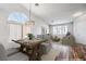 Staged dining room flowing into the living room featuring stylish decor and ample natural light at 10649 Bella Ordaz Way, Las Vegas, NV 89141